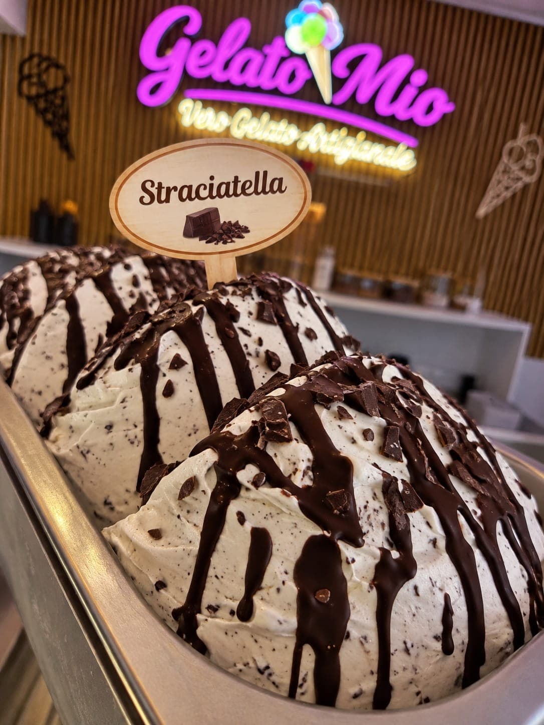 Bak stracciatella-gelato met pure chocoladesaus en chocoladestukjes bij Gelato Mio